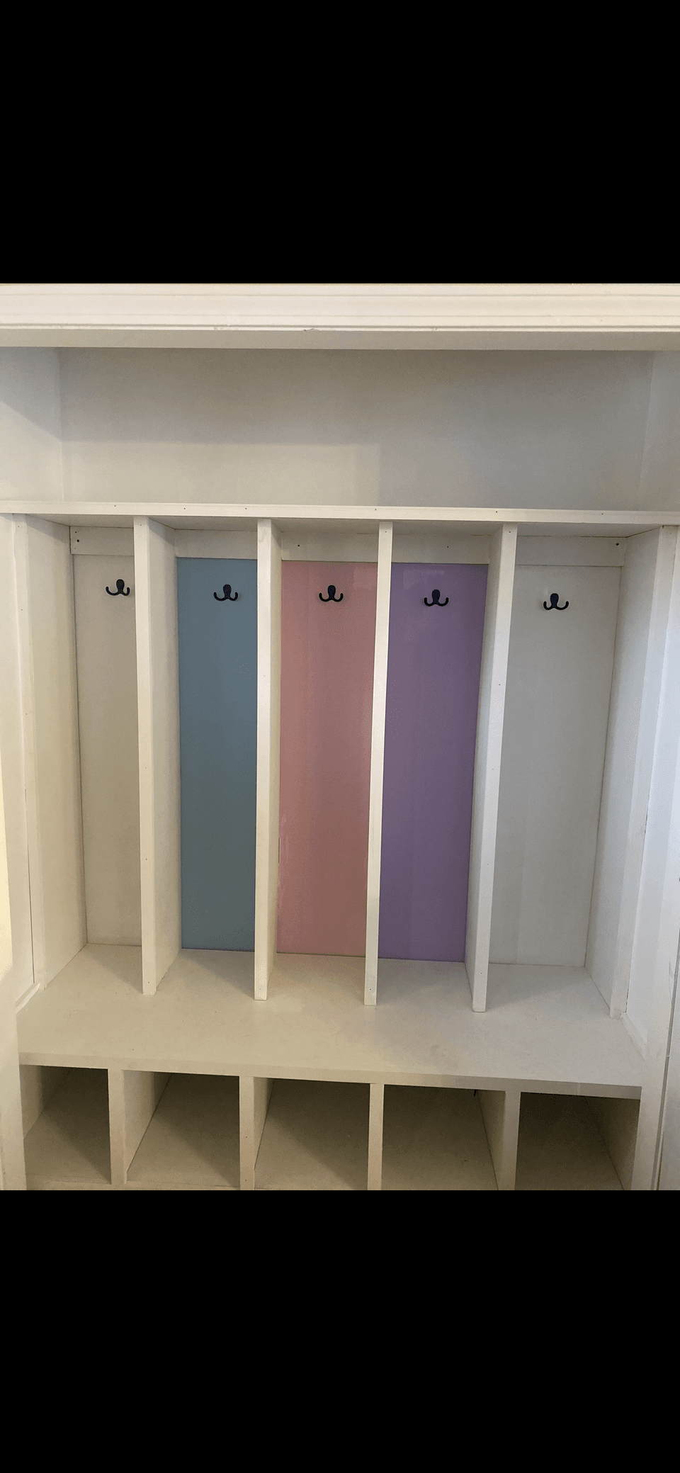 Custom mudroom cubbies with painted accent panels